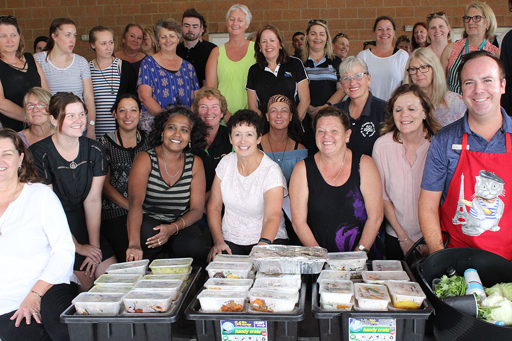 Team members cooking together in the Community Kitchen challenge for team building