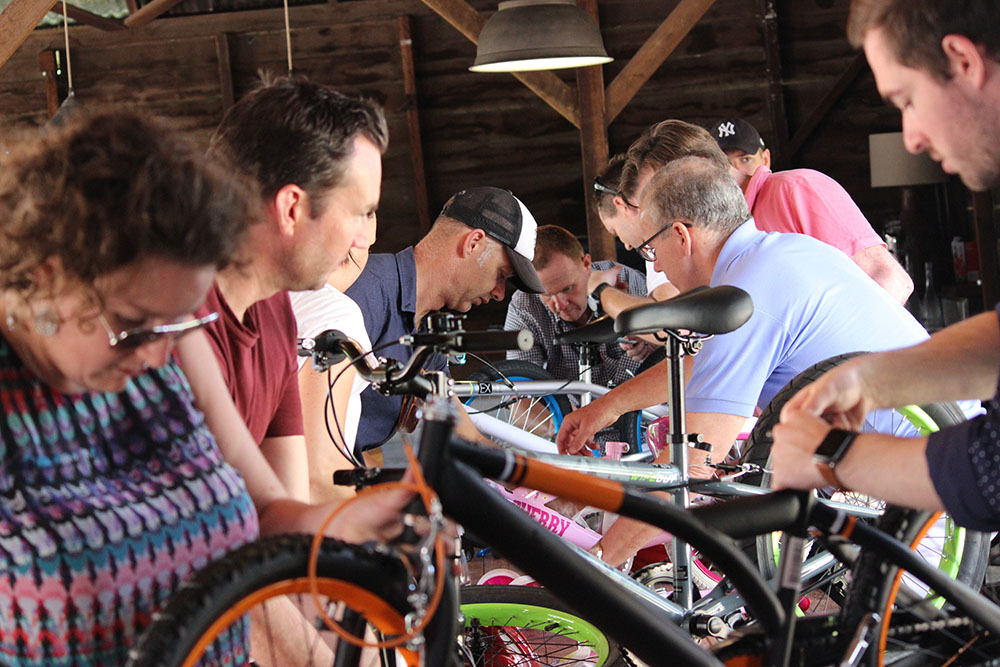 Corporate team members participating in a social responsibility activity indoors