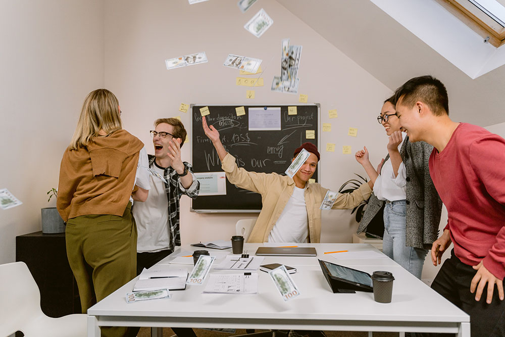 Office team working together on a project, demonstrating improved collaboration and communication after a team building event.