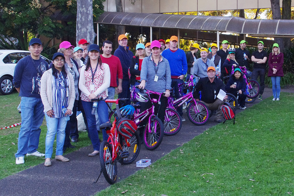 A corporate team assembling bicycles for children, a CSR team building activity organized by XL Events.