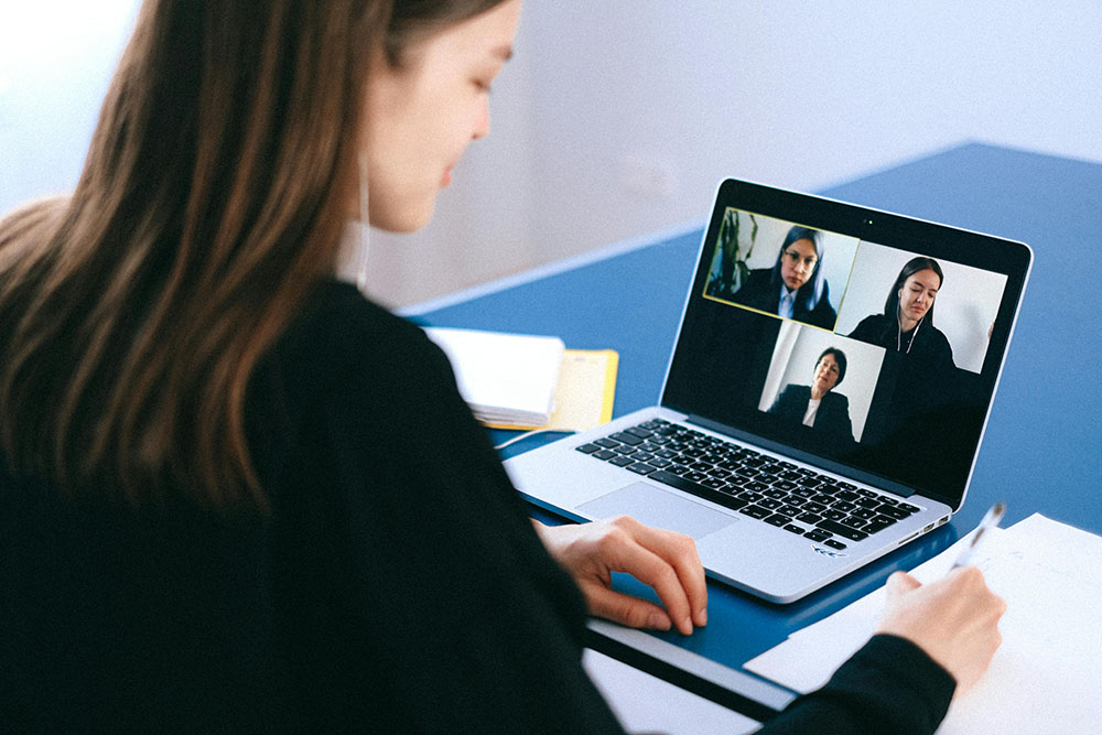Remote employees participating in a virtual team-building activity via video call.